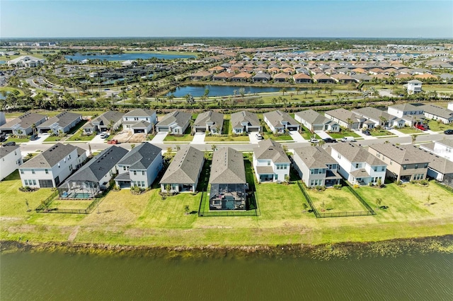 bird's eye view featuring a residential view and a water view