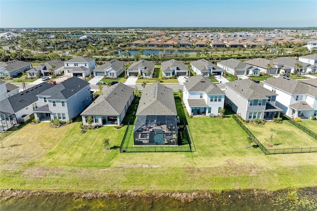 drone / aerial view featuring a residential view and a water view