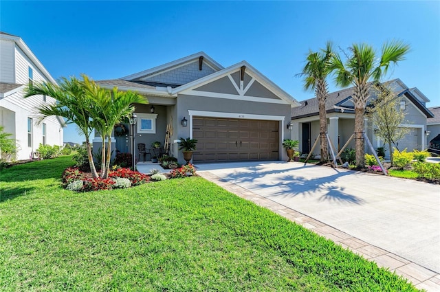 view of front facade with stucco siding, an attached garage, driveway, and a front yard