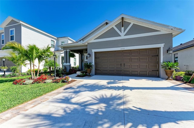 view of front facade featuring a garage, driveway, and stucco siding