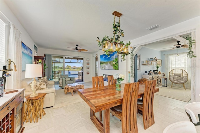 dining space featuring a textured ceiling, visible vents, and ceiling fan