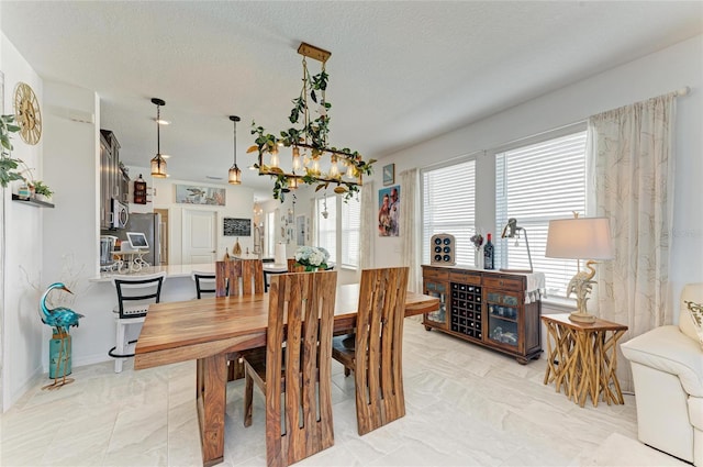 dining room with marble finish floor and a textured ceiling