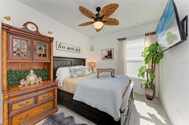 carpeted bedroom with baseboards, lofted ceiling, and a ceiling fan