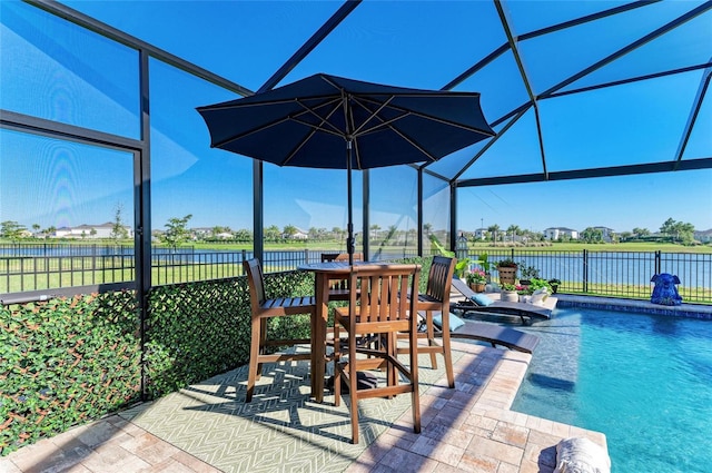 exterior space featuring a lanai, a fenced in pool, a patio, and fence