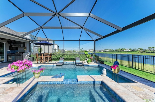 view of swimming pool featuring a patio, fence, grilling area, exterior kitchen, and a lanai