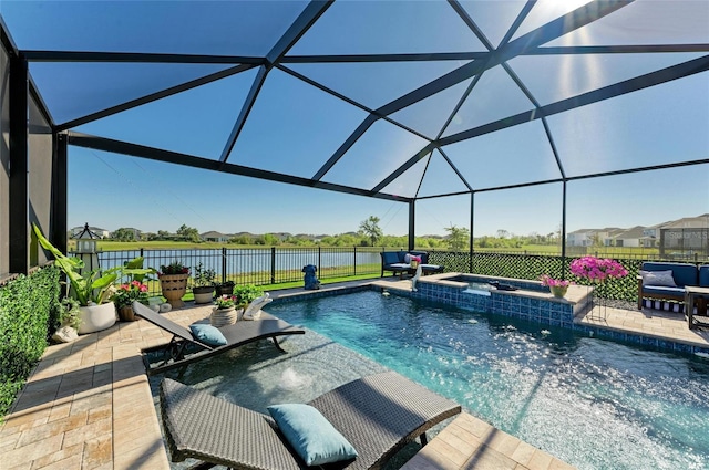 view of swimming pool with glass enclosure, a patio, fence, and a water view