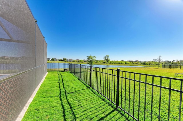 view of yard featuring a water view and fence