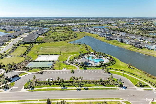 drone / aerial view featuring a residential view and a water view