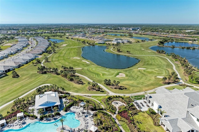 drone / aerial view with a water view and golf course view