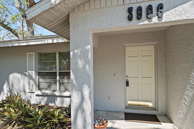 doorway to property with stucco siding