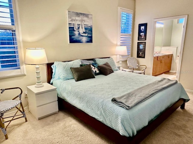 bedroom featuring carpet and connected bathroom