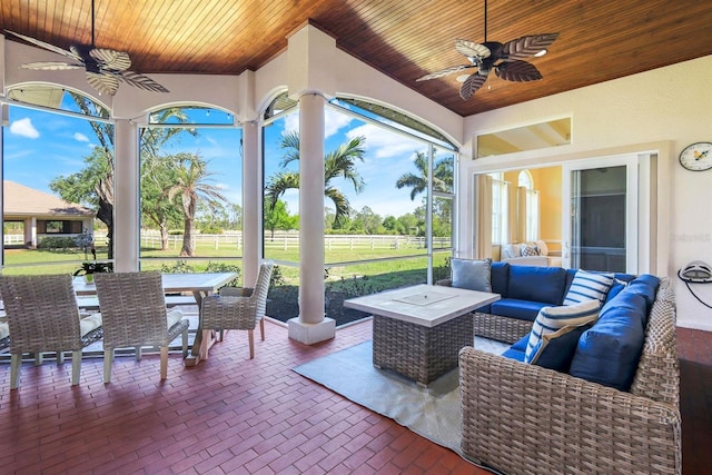 view of patio with an outdoor hangout area, outdoor dining area, ceiling fan, and fence