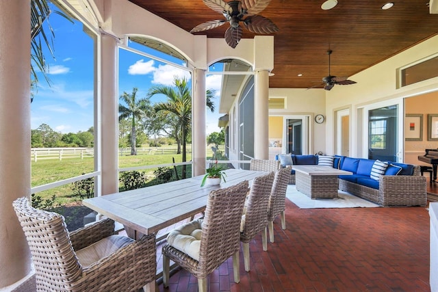 sunroom featuring wood ceiling and ceiling fan