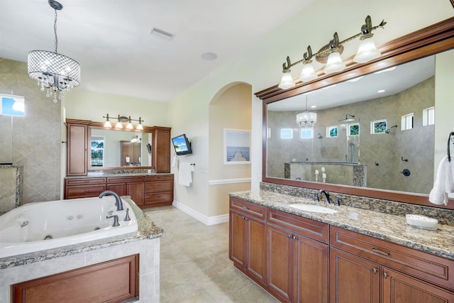 bathroom featuring visible vents, a walk in shower, a jetted tub, an inviting chandelier, and vanity