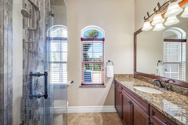 bathroom featuring vanity, baseboards, tile patterned flooring, an enclosed shower, and toilet