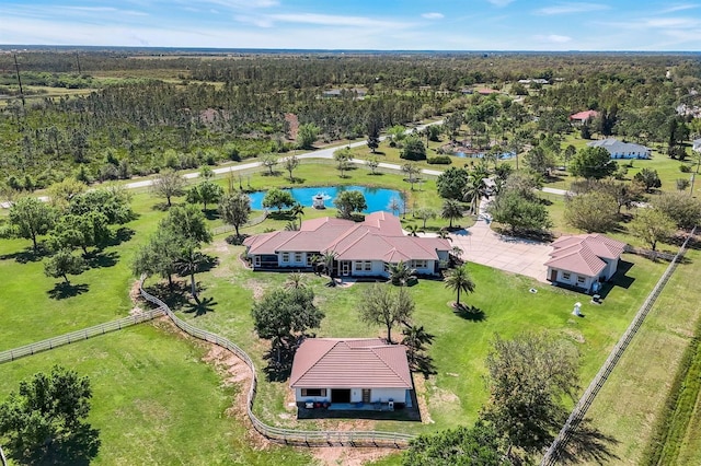 drone / aerial view with a wooded view