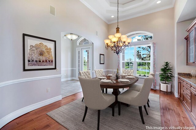 3551 Ridgeland Ct, Punta Gorda, FL 33982 - dining space with a wealth of natural light, a chandelier, baseboards, and light wood-style flooring