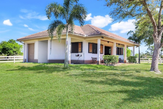 3551 Ridgeland Ct, Punta Gorda, FL 33982 - back of house with a garage, a tiled roof, a yard, and fence