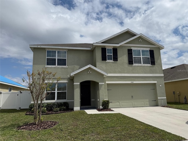 view of front of house with a front lawn, fence, stucco siding, driveway, and an attached garage