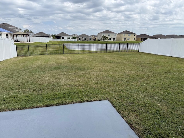 view of yard featuring a residential view and a fenced backyard