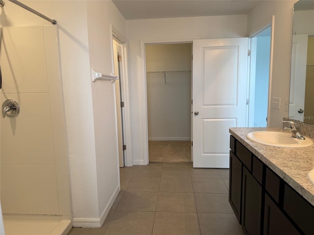 full bath with tile patterned floors, a shower, double vanity, and a sink