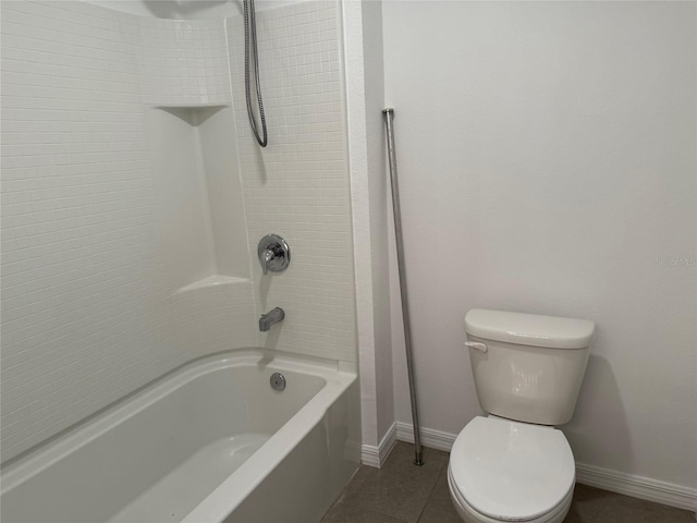 bathroom featuring tile patterned floors, toilet, bathing tub / shower combination, and baseboards