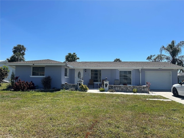 ranch-style home featuring a garage, concrete driveway, and a front lawn