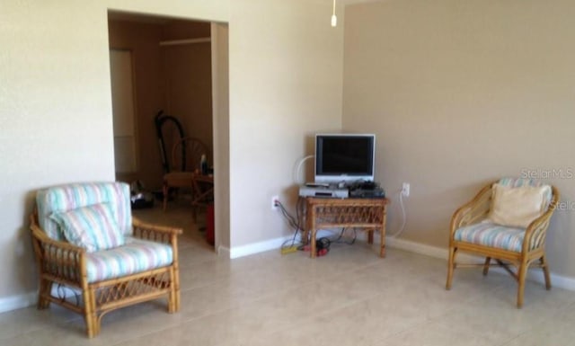 living area with tile patterned floors and baseboards