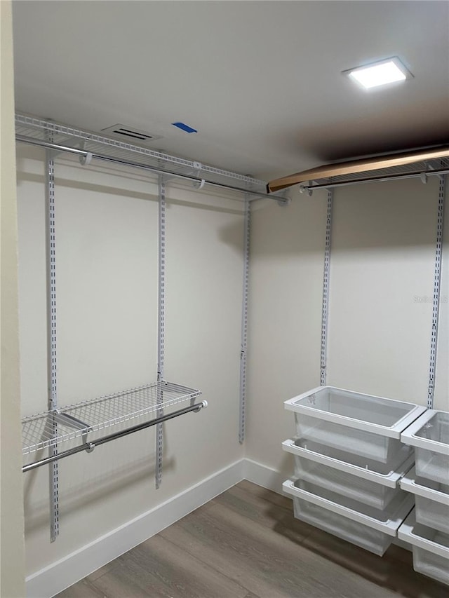 walk in closet featuring wood finished floors and visible vents