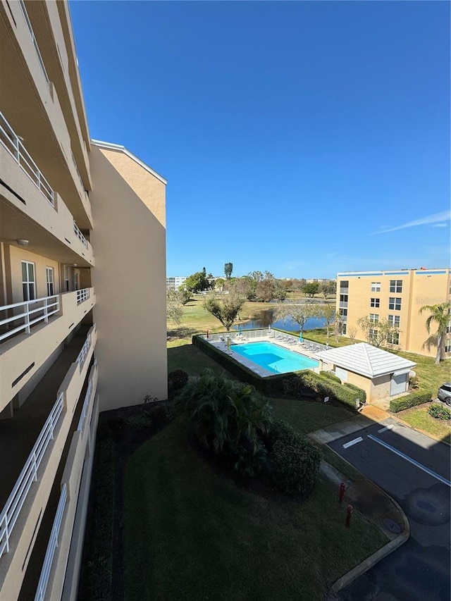 view of swimming pool with a fenced in pool and a lawn