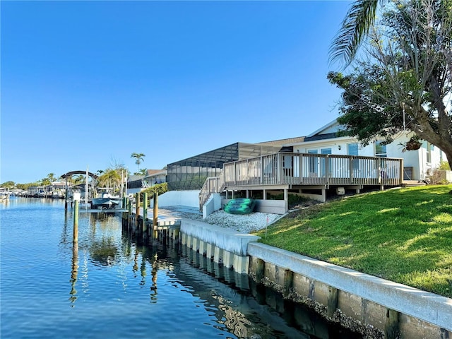 dock area featuring boat lift, a lawn, and a water view