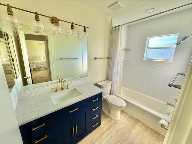 ensuite bathroom with vanity, wood finished floors, ensuite bath, toilet, and shower / tub combo with curtain