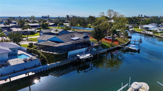 drone / aerial view featuring a residential view and a water view