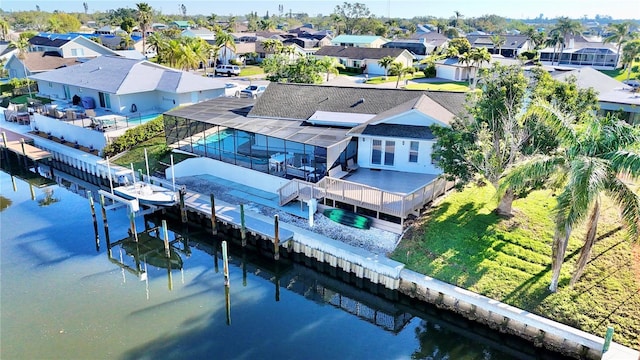 drone / aerial view featuring a residential view and a water view