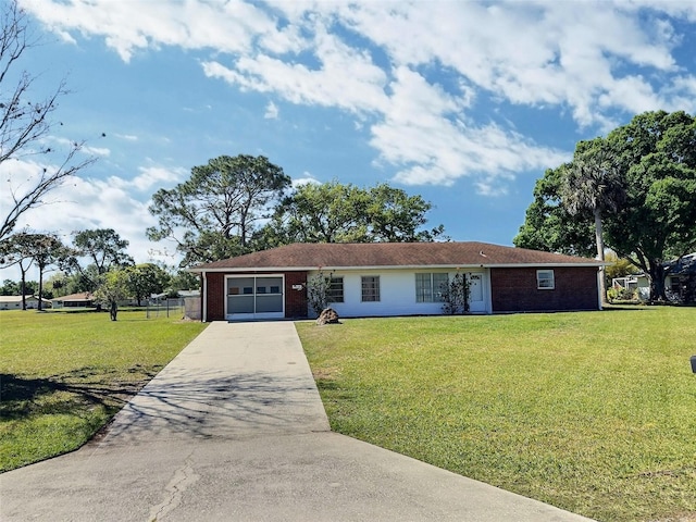 single story home featuring concrete driveway, a garage, brick siding, and a front yard