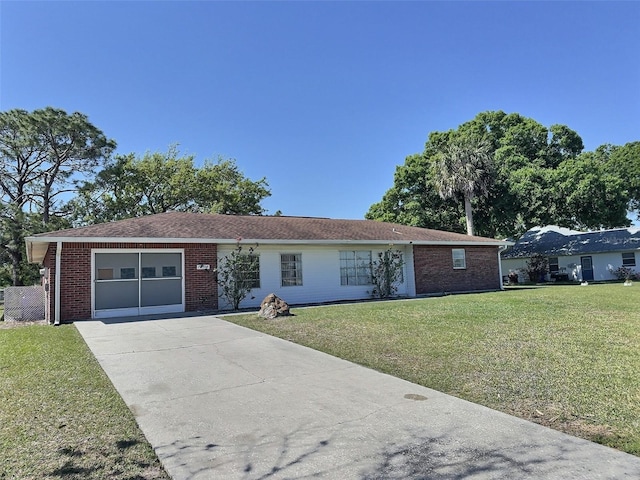 ranch-style house with brick siding, driveway, an attached garage, and a front lawn