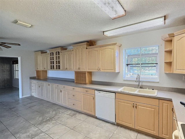 kitchen with ceiling fan, light brown cabinetry, light tile patterned floors, white dishwasher, and a sink