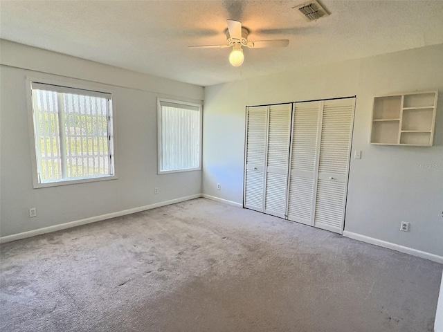 unfurnished bedroom featuring a closet, visible vents, carpet flooring, and baseboards