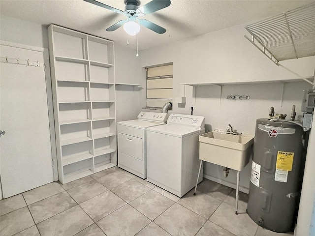 clothes washing area with laundry area, separate washer and dryer, water heater, a sink, and ceiling fan