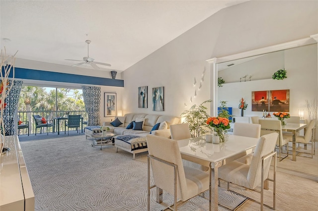 dining room featuring high vaulted ceiling, light carpet, and ceiling fan