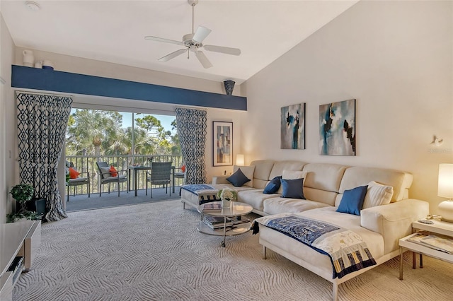 carpeted living room with a ceiling fan and vaulted ceiling