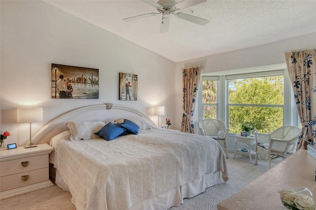 carpeted bedroom with a textured ceiling, ceiling fan, and vaulted ceiling