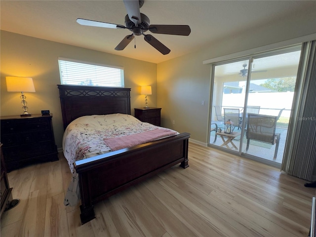 bedroom featuring light wood finished floors, baseboards, multiple windows, and access to outside