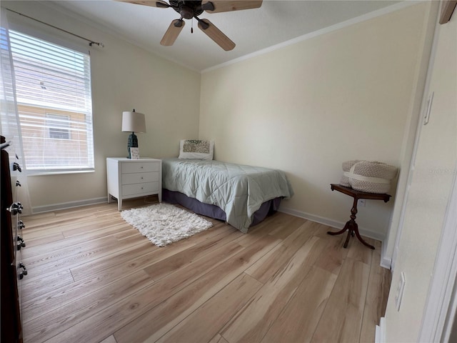 bedroom with light wood finished floors, ceiling fan, baseboards, and ornamental molding