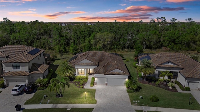 birds eye view of property with a forest view