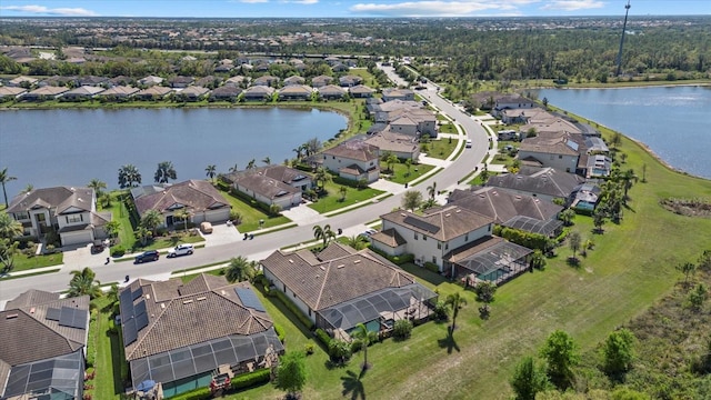 drone / aerial view featuring a residential view and a water view