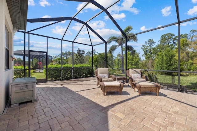 view of patio / terrace featuring glass enclosure