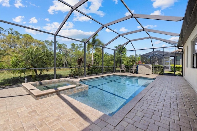 view of pool with a lanai, a patio area, and a pool with connected hot tub