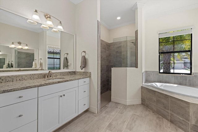 full bath featuring a garden tub, vanity, walk in shower, and crown molding