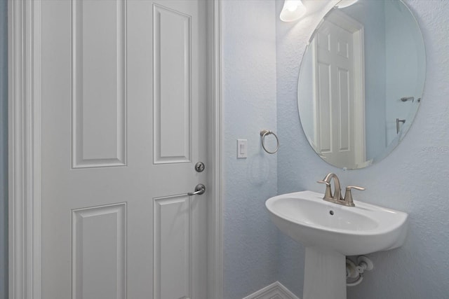 bathroom with a textured wall